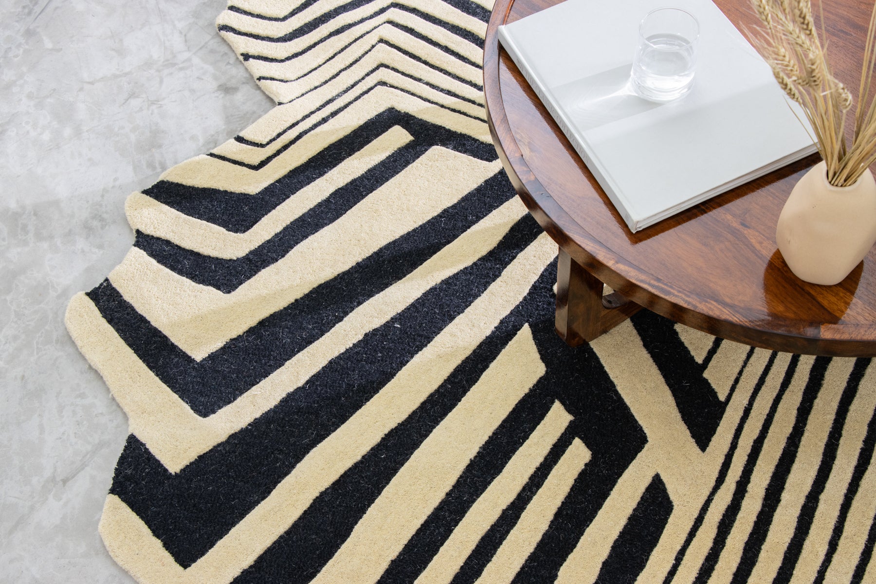 Corner view black beige hand tufted irregular rug | Beyond Rugs USA