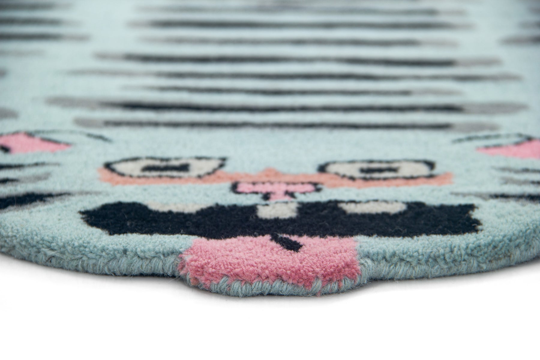Side angle of turquoise flat cat rug showing irregular cat silhouette and pile thickness | Beyond Rugs