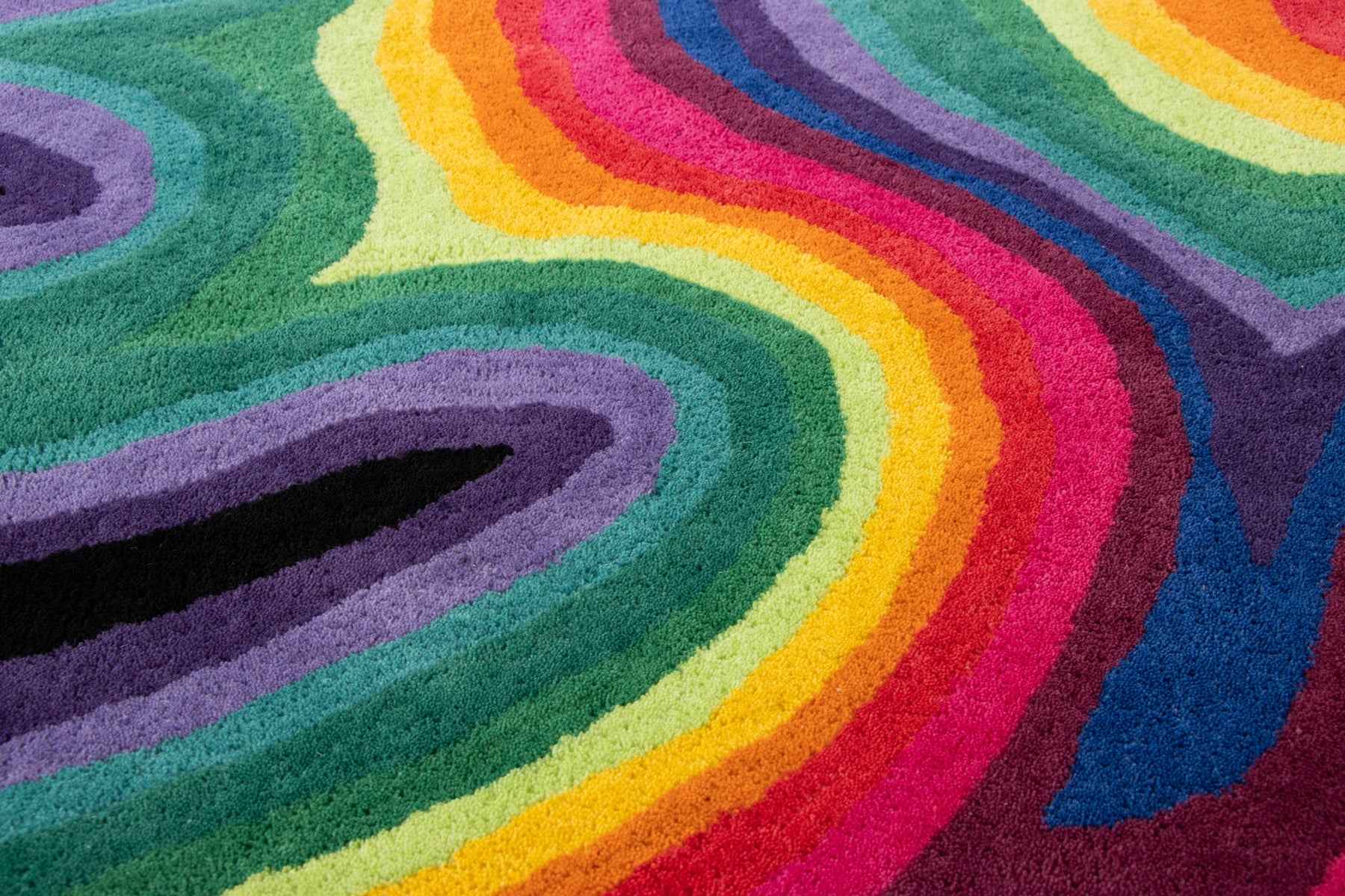 Close-up texture detail Paint Melts Rhapsody rug showing rainbow gradient pattern and medium pile height