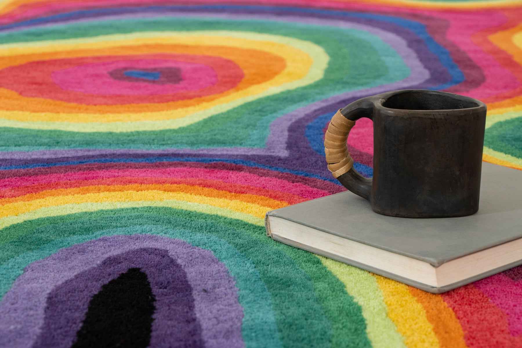 Paint Melts Rhapsody rug styled in modern interior setting - bold flowing pattern multicolor area rug placement