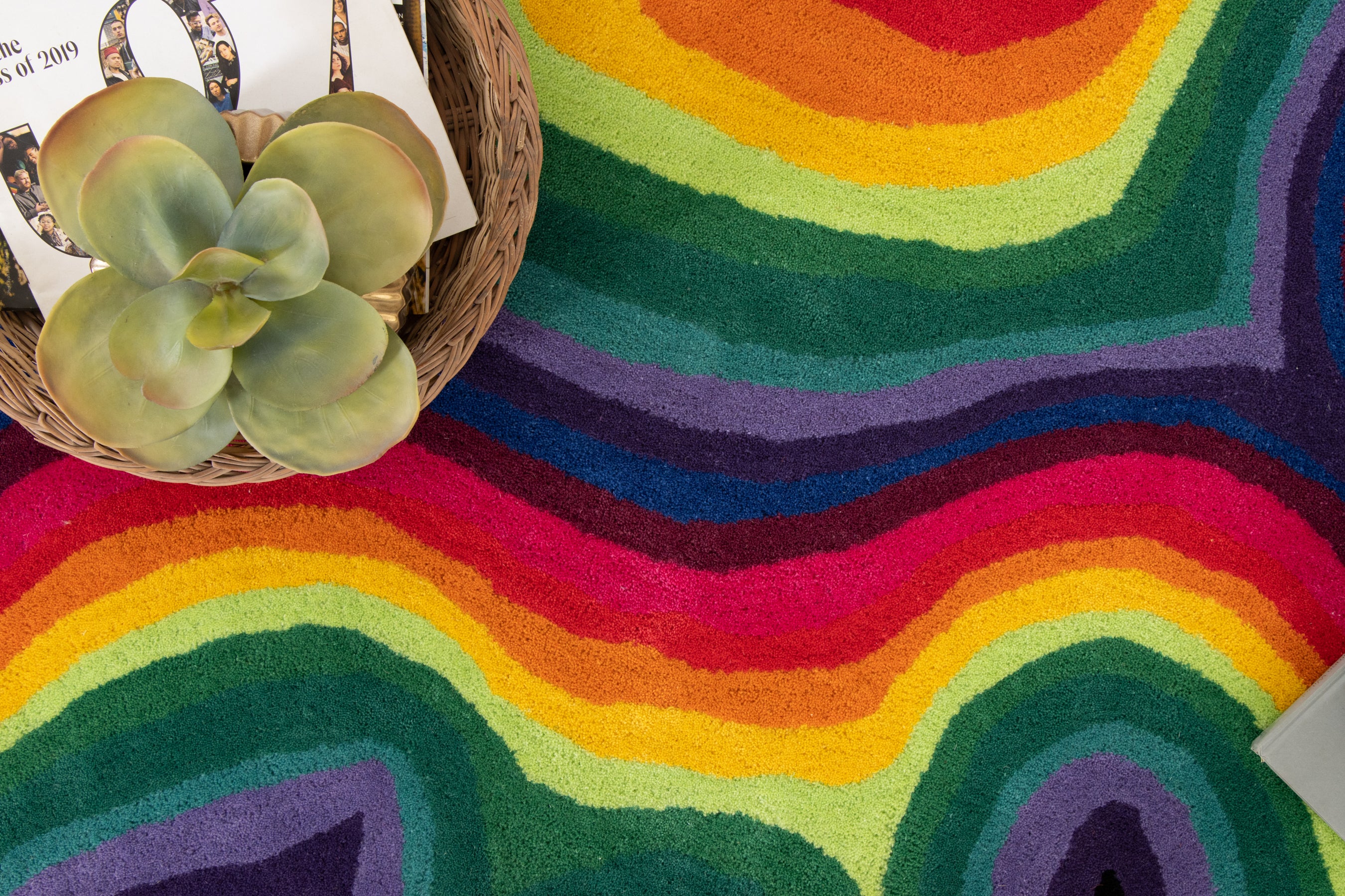 Paint Melts Rhapsody area rug corner detail shot - irregular shape with vibrant rainbow swirl pattern