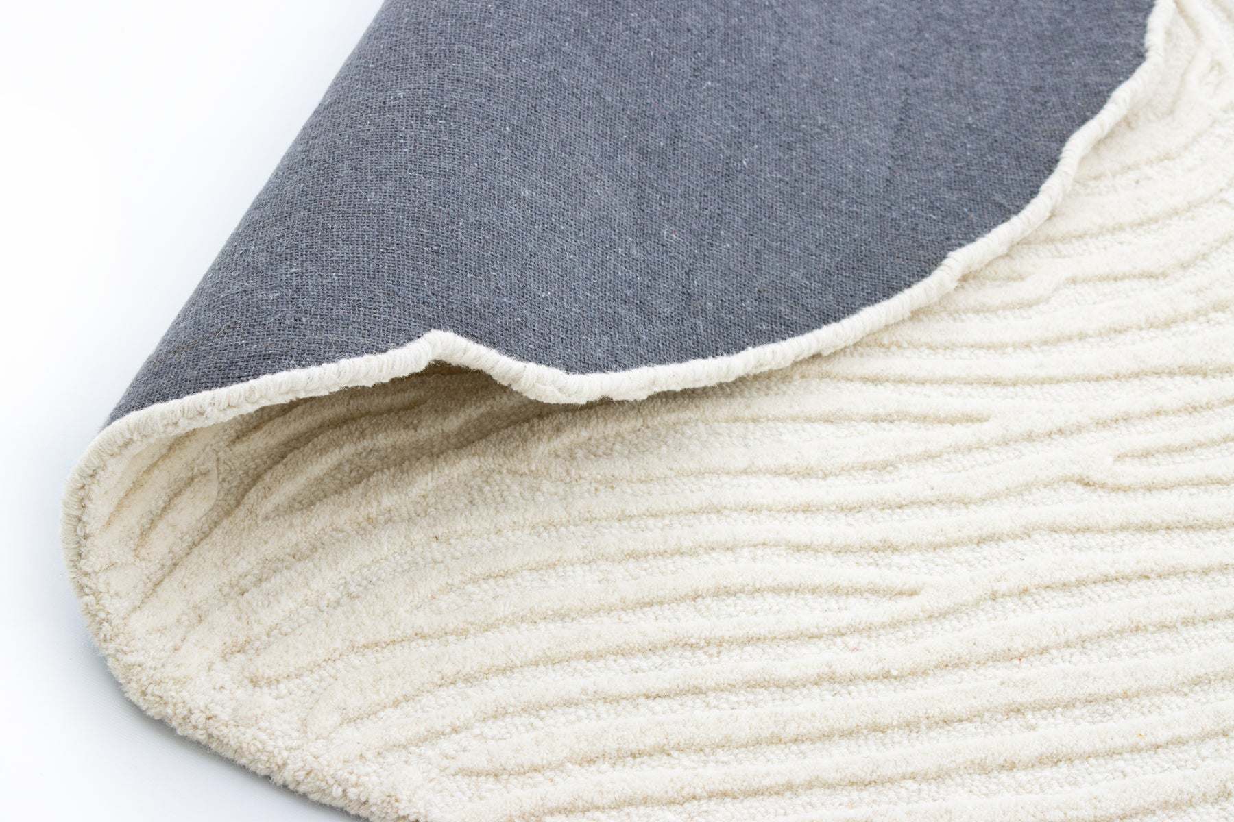 Ivory thumb print rug under white side table | Beyond Rugs USA