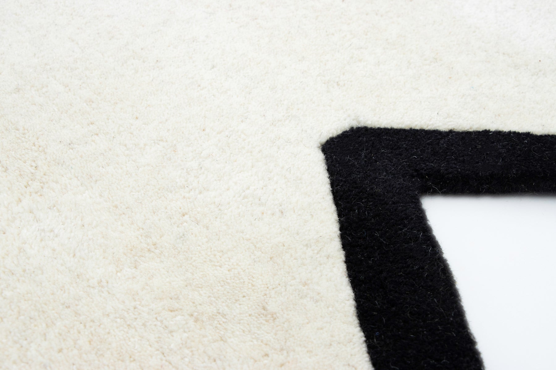 Open book on ivory hexagon irregular wool rug | Beyond Rugs USA