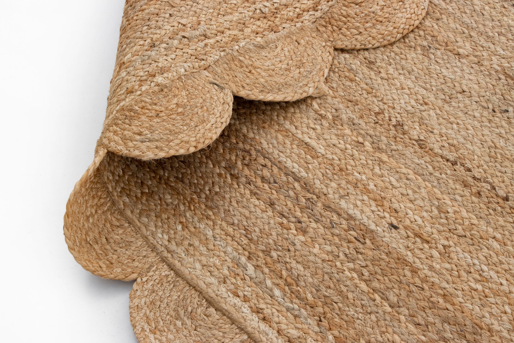 Close-up of a textured natural fiber rug with a cable knit pattern