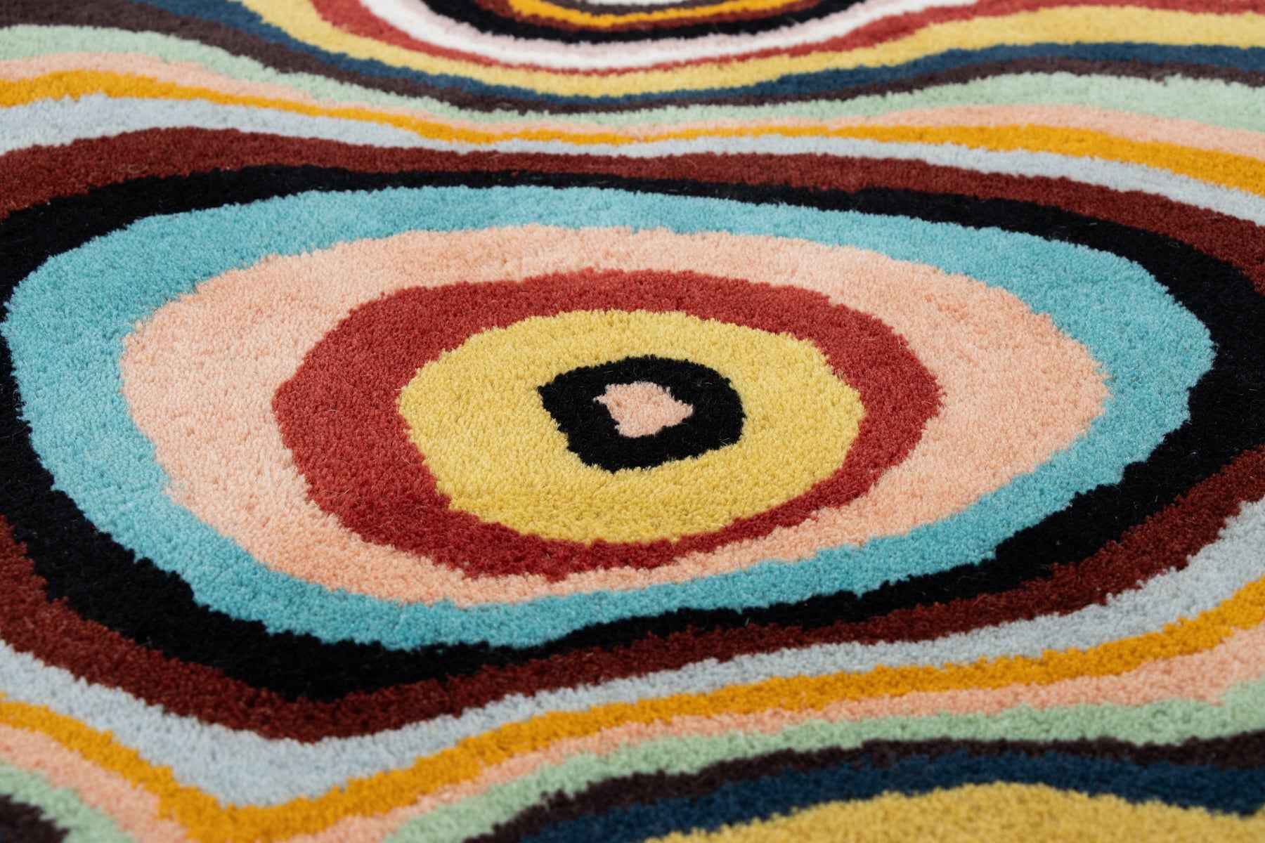 Detail shot of Paint Melts rug edges and finish highlighting hand-tufted construction