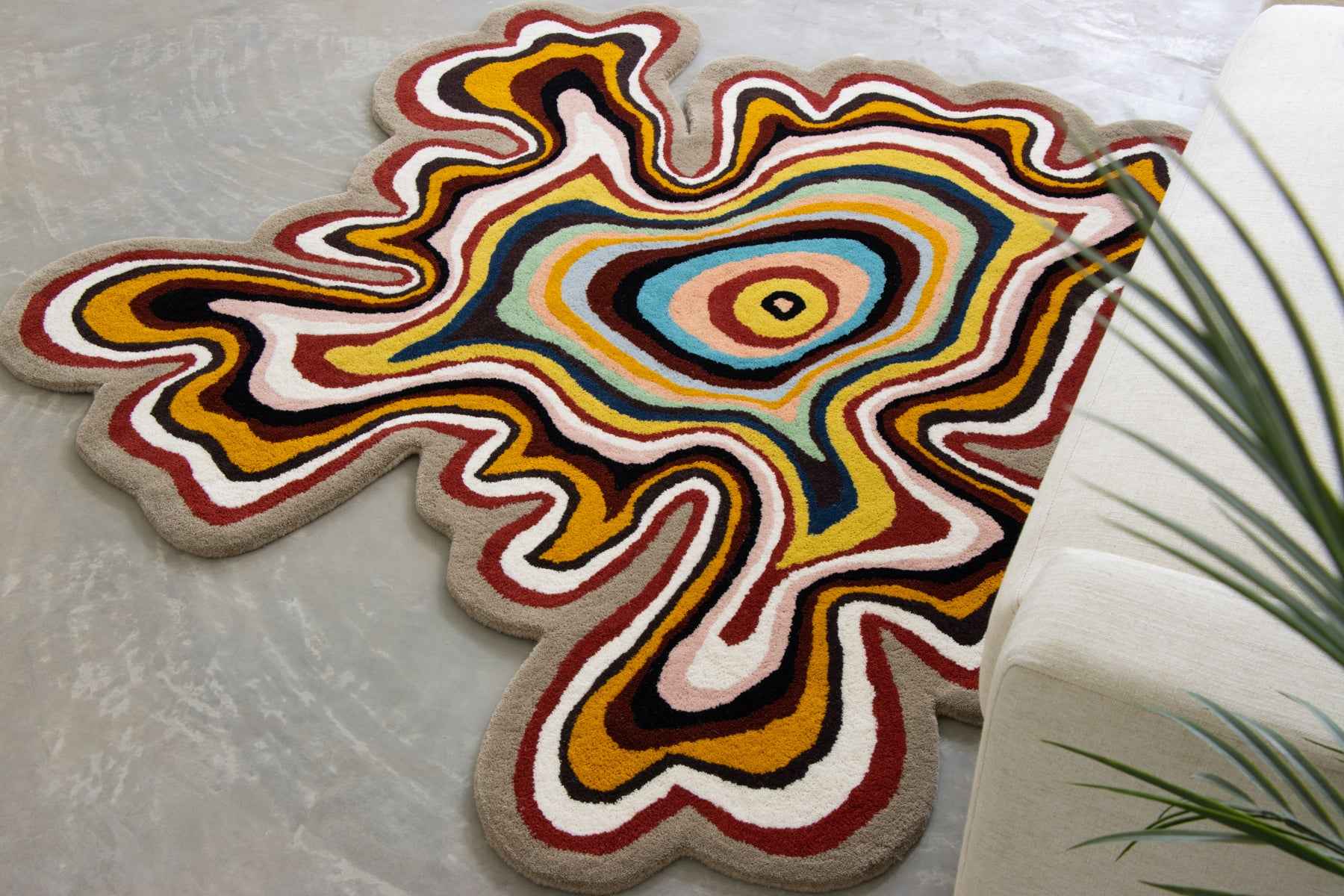 Paint Melts irregular abstract swirl rug styled in a modern living room interior