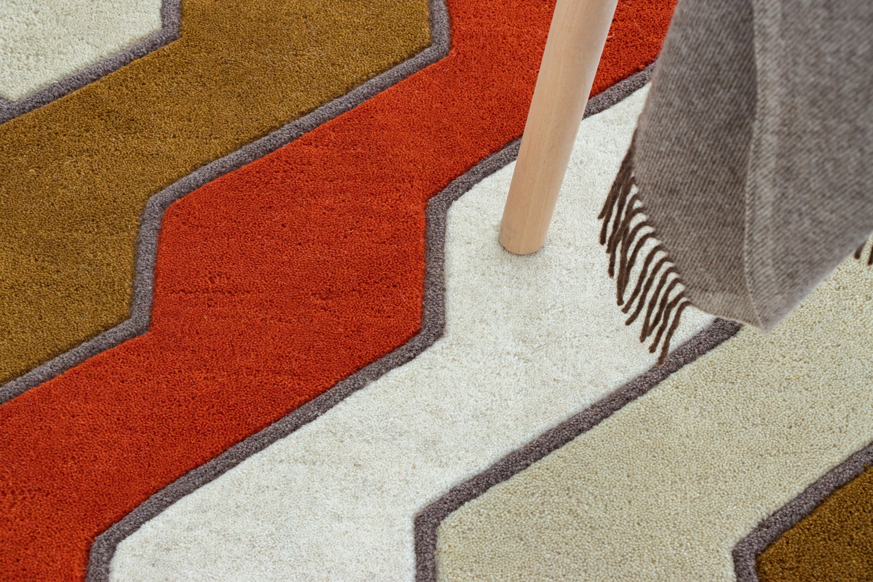 Close-up red orange hand tufted irregular rug stripe | Beyond Rugs USA