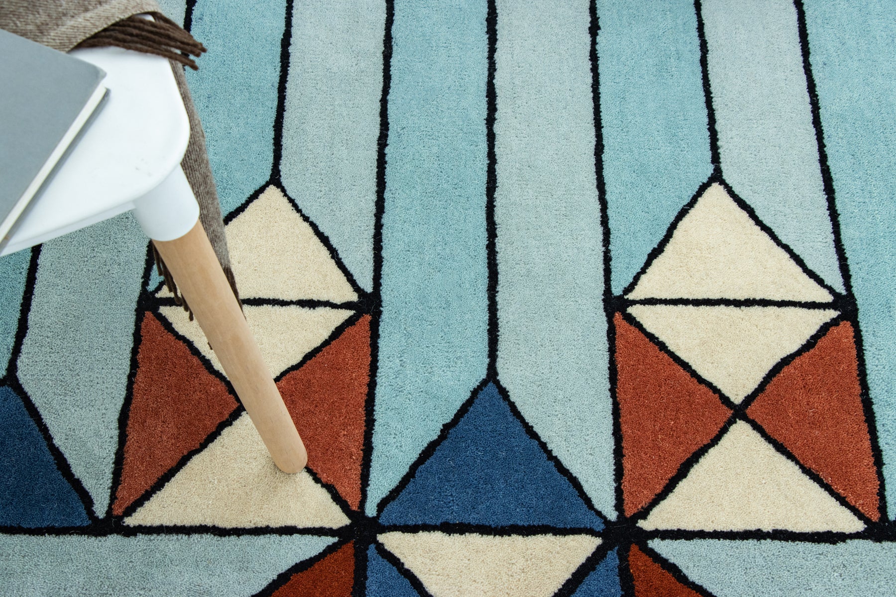Designer blue and rust geometric rug with layered diamond motifs | Beyond Rugs