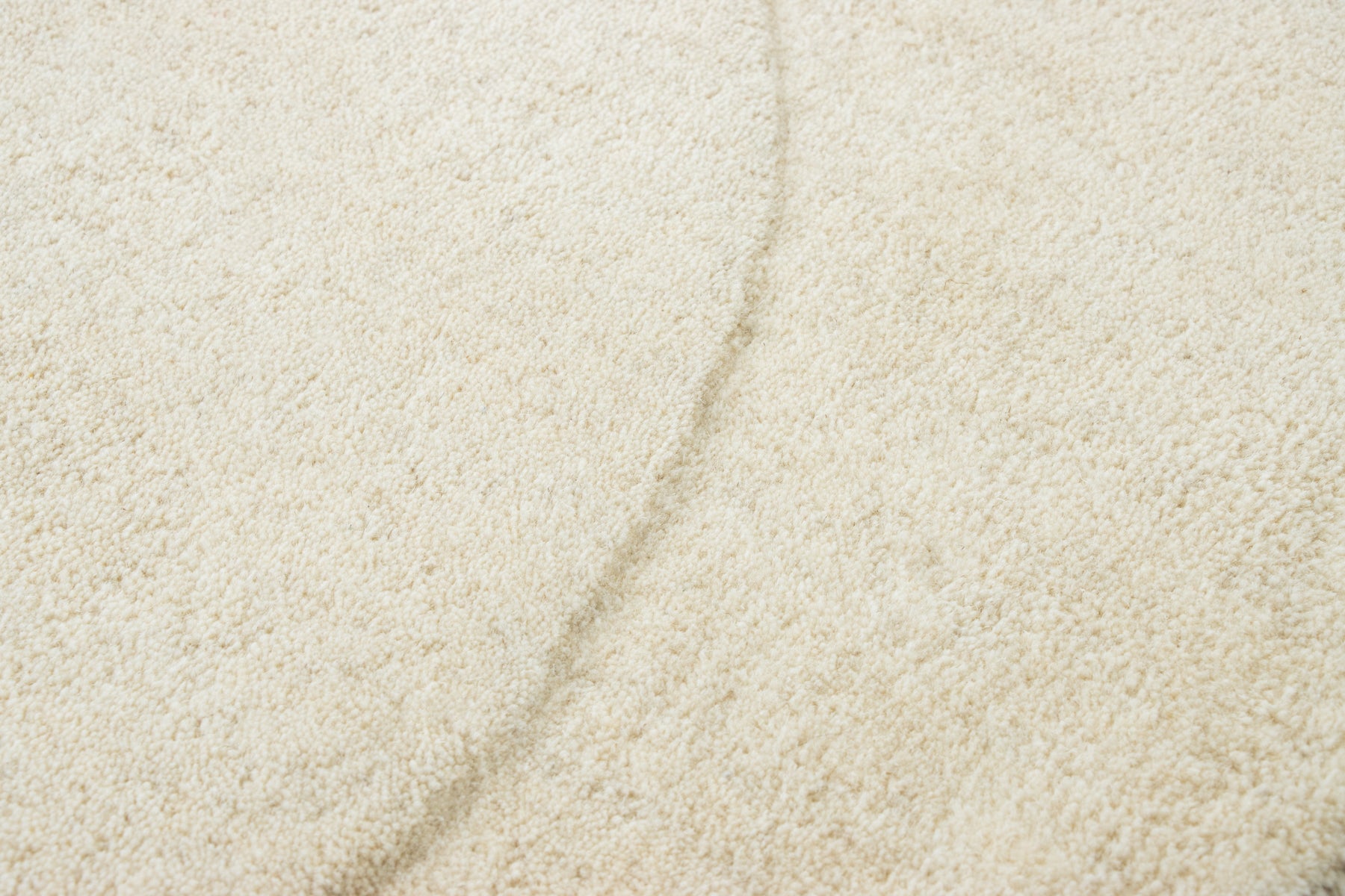 Modern ivory bean shaped area rug in premium wool, soft textured carpet | Beyond Rugs