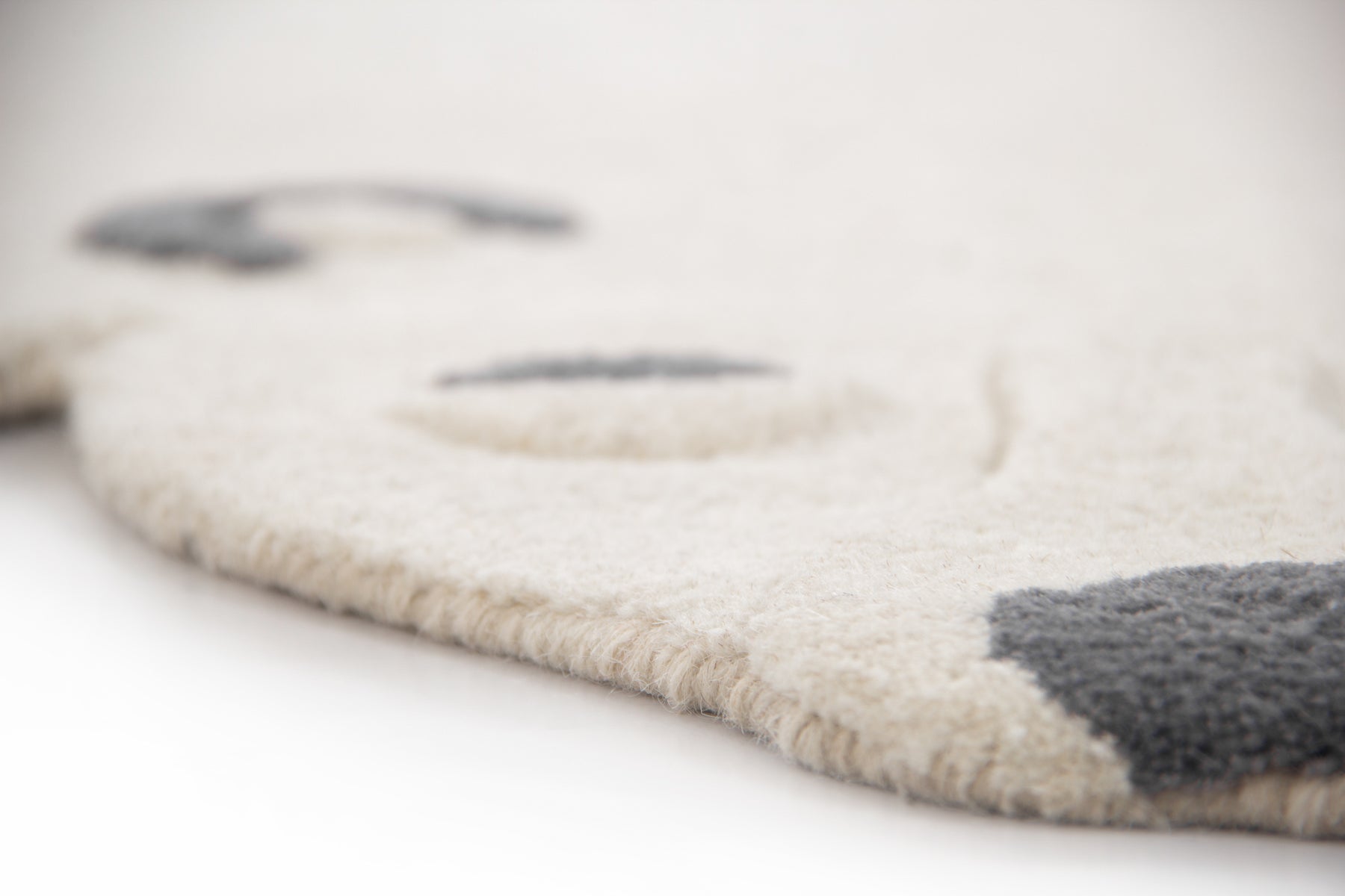 Texture detail of soft ivory wool on arctic bear irregular cut-out silhouette rug | Beyond Rugs
