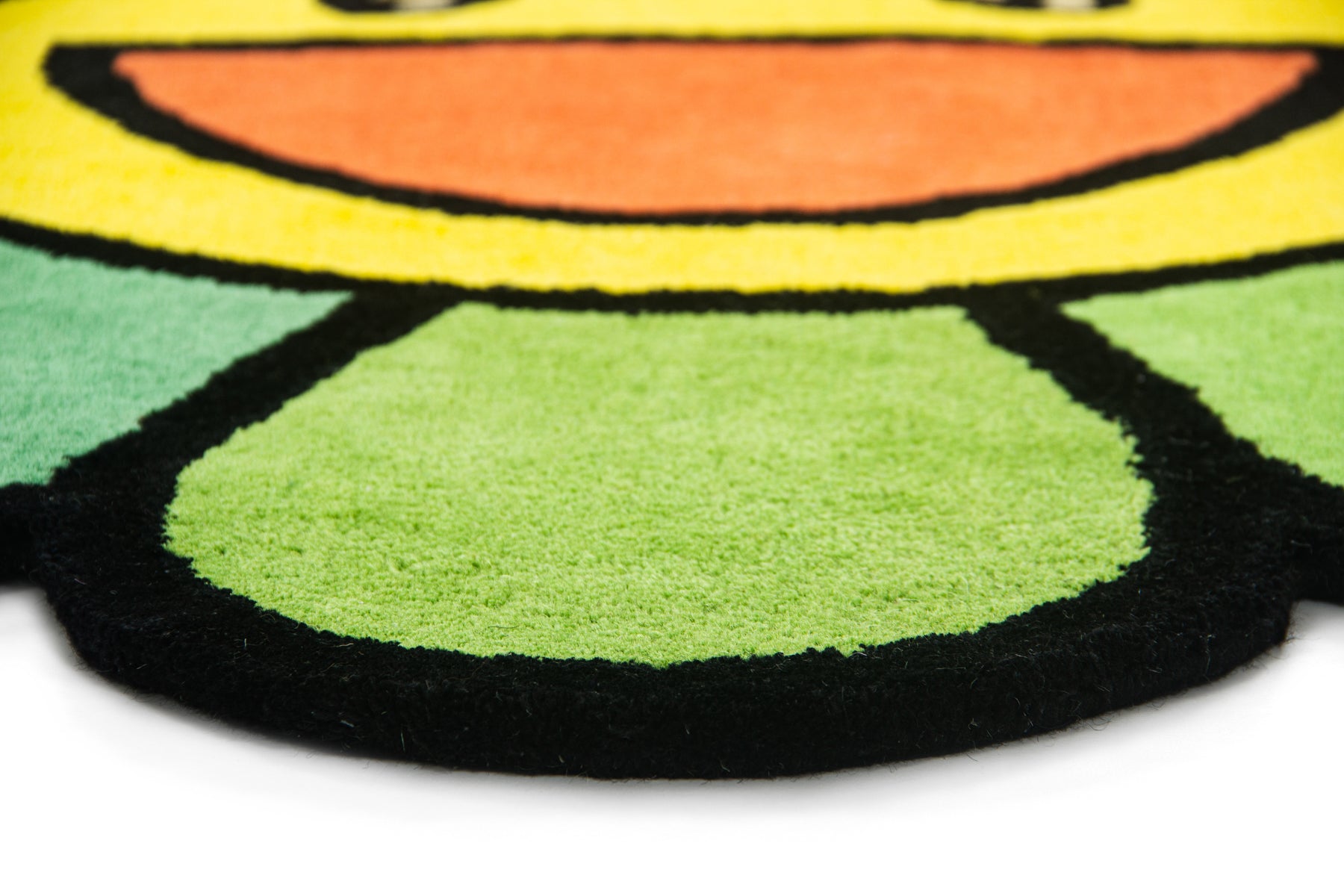 Bottom petal texture detail of Murakami rainbow flower rug with green and yellow wool pile | Beyond Rugs