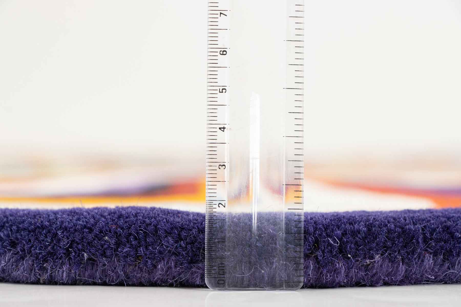 Person standing on Paint Melts Radiant multicolor rug - lifestyle detail shot showing scale and texture