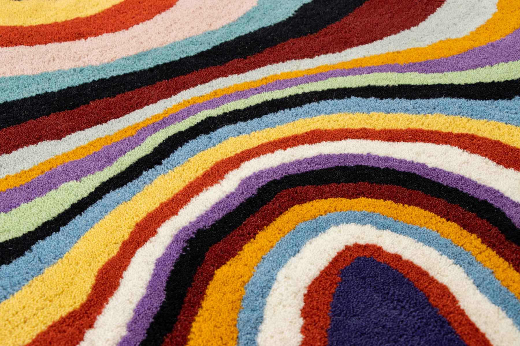 Close-up texture detail of Paint Melts Radiant rug showing vibrant swirl patterns and medium pile height