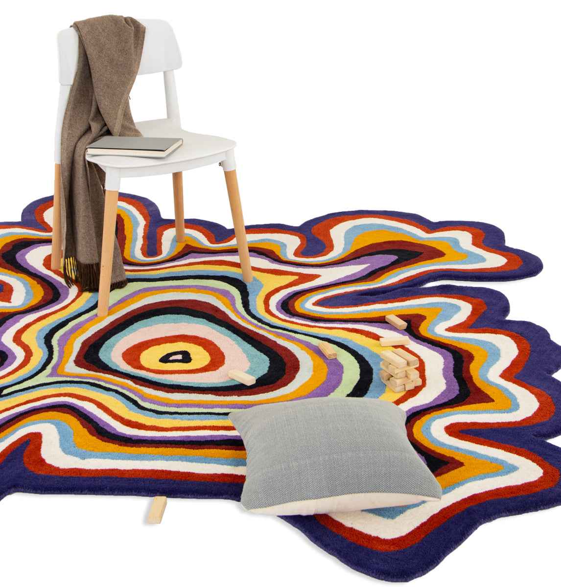 Paint Melts Radiant rug styled in modern living room with chair and cushion - multicolor hand-tufted area rug lifestyle shot