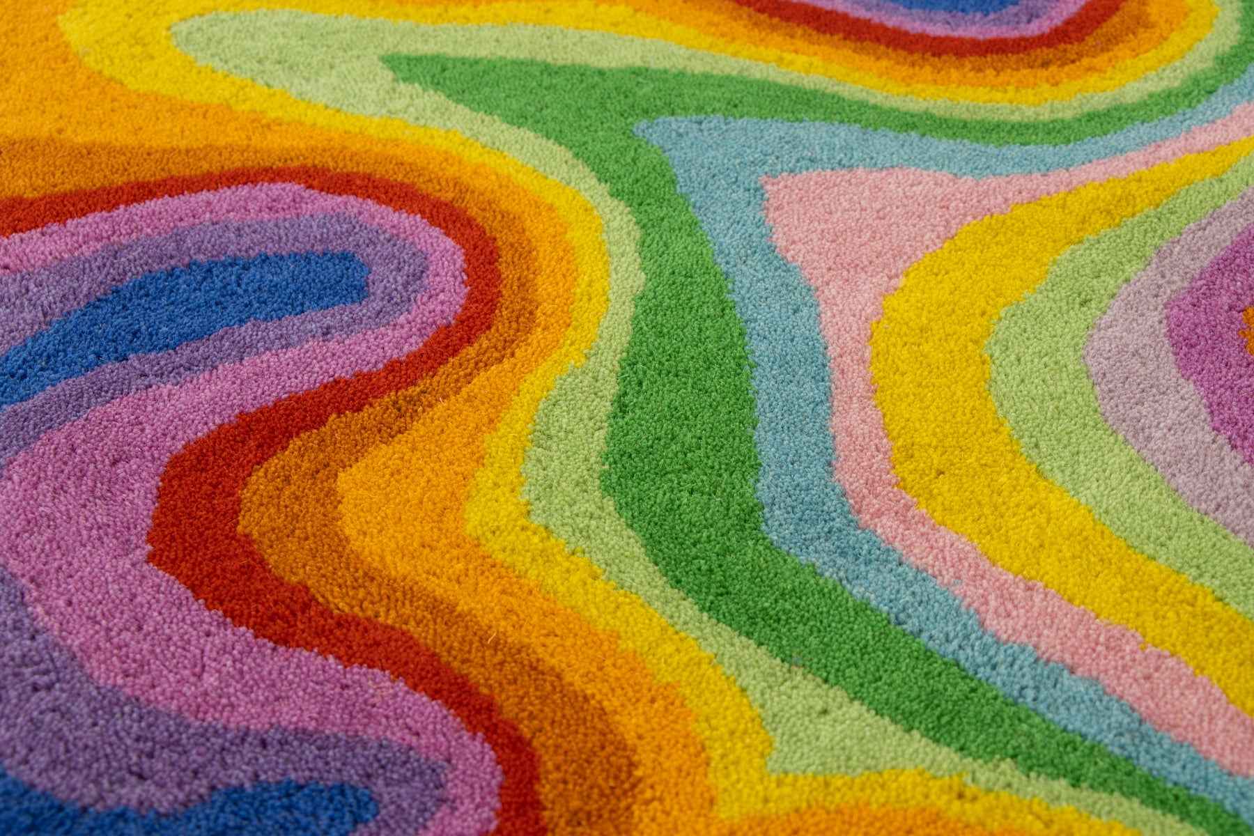 Close-up of Psychedelic rug pile showing rainbow wool bands in red, blue and green | Beyond Rugs