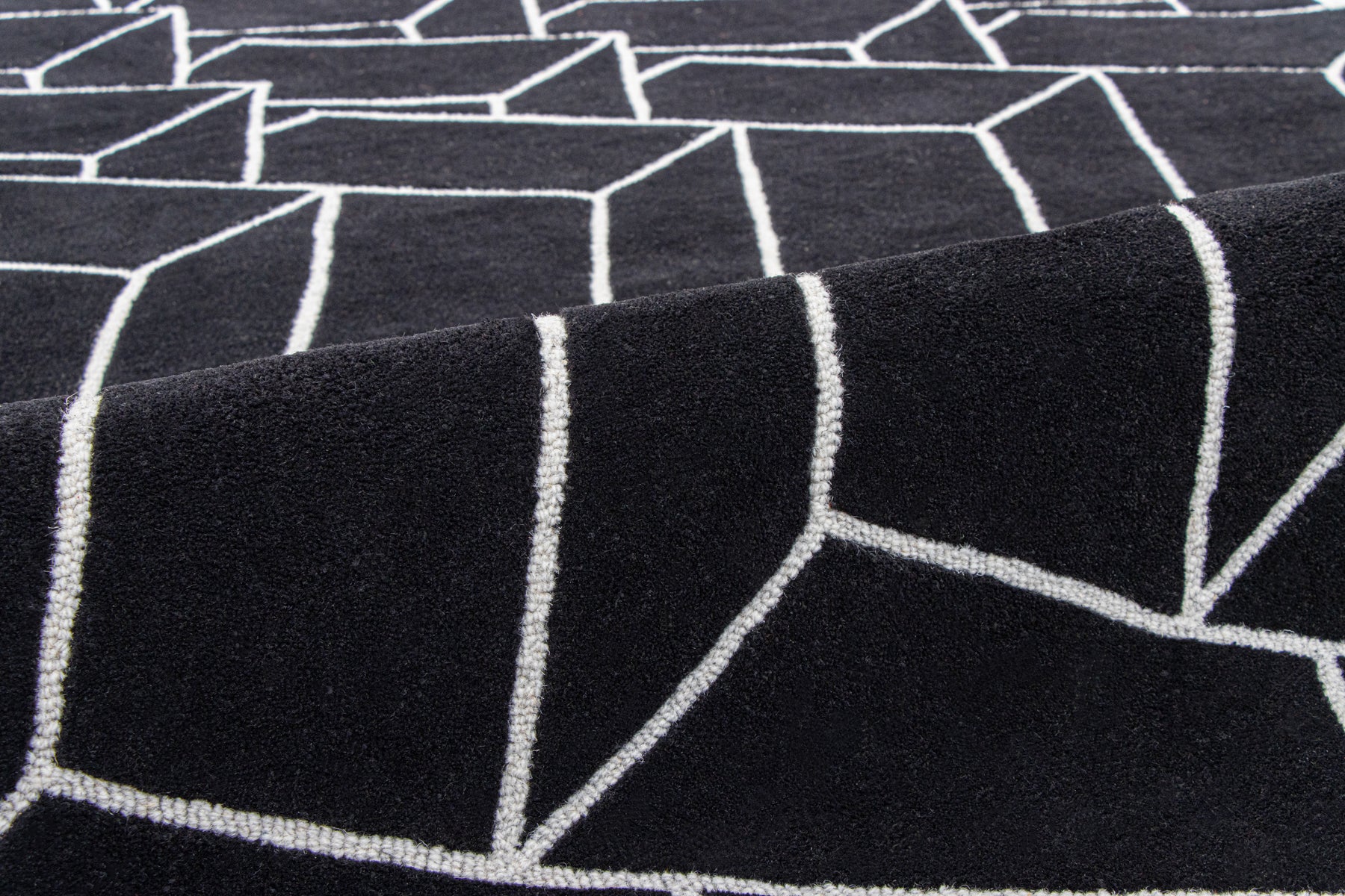 Close-up edge detail black irregular rug | Beyond Rugs USA