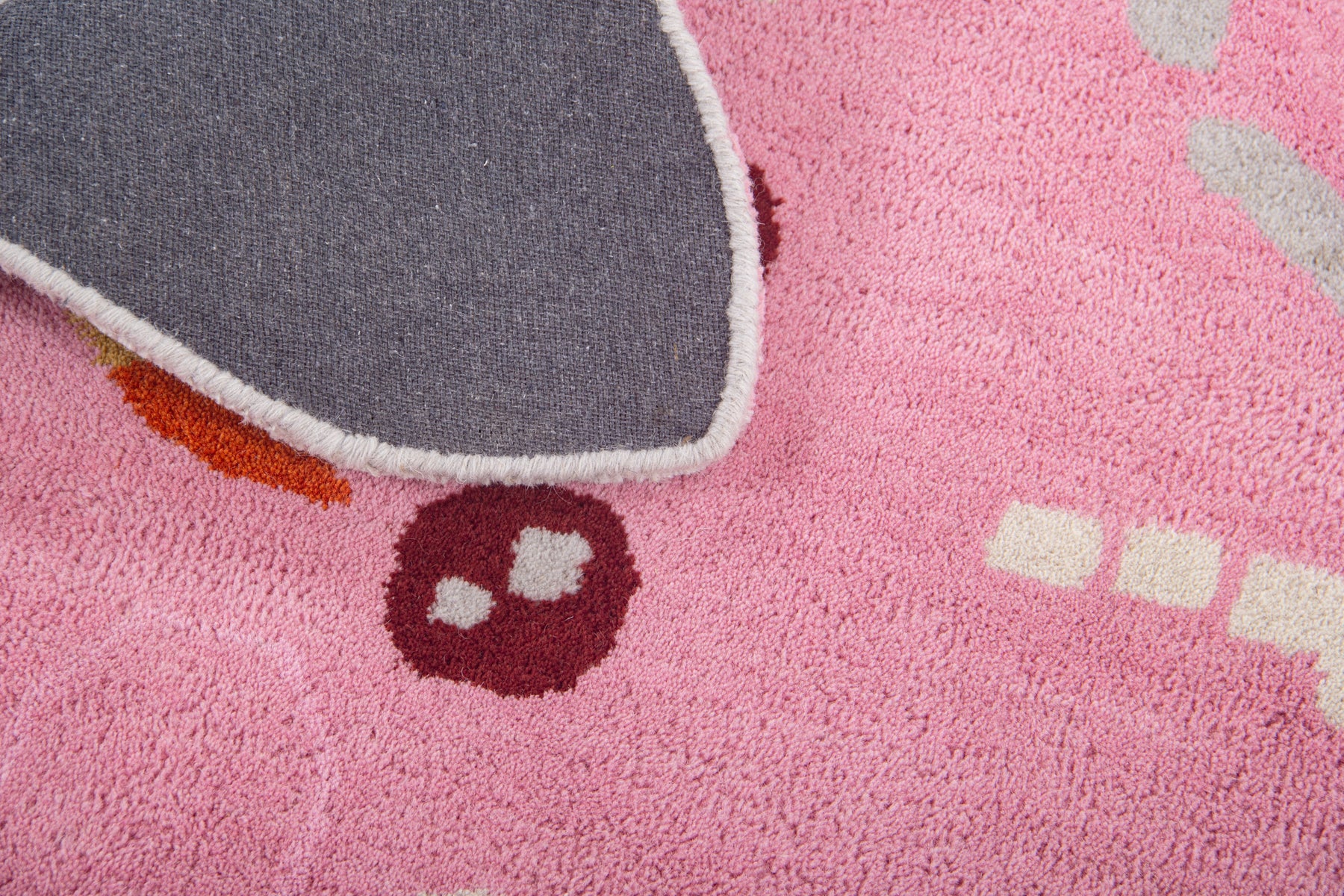 Back of pink starfish irregular rug showing grey canvas and cut-out starfish silhouette | Beyond Rugs