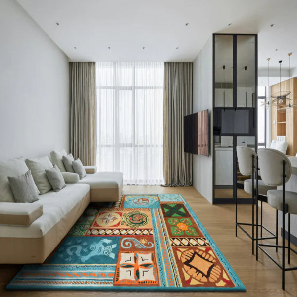 Modern living room with a colorful patterned rug, white sofa, and kitchen area.