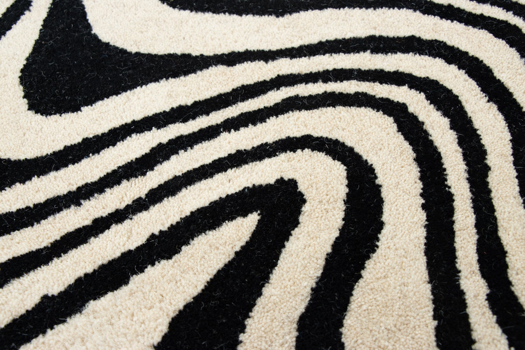 Designer black and ivory area rug with fluid splash inspired pattern | Beyond Rugs
